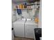 The laundry room has a washer, dryer, and storage shelf with cleaning and washing supplies at 6624 Socorro Dr, Las Vegas, NV 89108