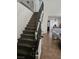 Staircase with carpet and iron railing leading to the second floor at 6624 Socorro Dr, Las Vegas, NV 89108