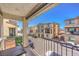 Apartment balcony with wrought iron railing, table, and a view of other apartments at 6952 Midnight Bronze St, North Las Vegas, NV 89086