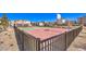 Community basketball court enclosed by a black metal fence and surrounded by desert landscaping at 6952 Midnight Bronze St, North Las Vegas, NV 89086