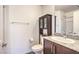 Bathroom featuring granite counters, dark wood cabinetry, and a shower in the background at 6952 Midnight Bronze St, North Las Vegas, NV 89086