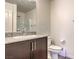 Bathroom featuring granite counters, dark wood cabinetry, and a glass enclosed shower at 6952 Midnight Bronze St, North Las Vegas, NV 89086