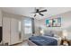 Staged bedroom with a plush bed, ceiling fan, and stylish decor at 6952 Midnight Bronze St, North Las Vegas, NV 89086