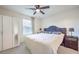 Well-lit bedroom with a ceiling fan, window and a spacious closet at 6952 Midnight Bronze St, North Las Vegas, NV 89086