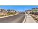 Gated community entrance with well-maintained landscaping and paved roads, offering secure and stylish living at 6952 Midnight Bronze St, North Las Vegas, NV 89086