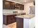 Modern kitchen featuring dark wood cabinets, stainless steel appliances, and granite countertops at 6952 Midnight Bronze St, North Las Vegas, NV 89086