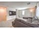Spacious living room offering a large sectional sofa and wall-mounted TV at 6952 Midnight Bronze St, North Las Vegas, NV 89086