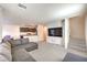 Open living area with a sofa, view of kitchen, and staircase to the next floor at 6952 Midnight Bronze St, North Las Vegas, NV 89086