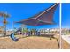 Community playground with a large shade structure, slides, and playground equipment at 6952 Midnight Bronze St, North Las Vegas, NV 89086