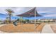 Community playground with shaded structure, offering a safe and fun area for children to play and socialize at 6952 Midnight Bronze St, North Las Vegas, NV 89086