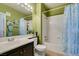 Bathroom with a shower-tub combo, decorative green walls, and a vanity sink at 7700 Constanso Ave # 204, Las Vegas, NV 89128