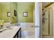 Stylish bathroom featuring double sinks, bathtub, and shower, with a calming green color scheme for relaxation at 7700 Constanso Ave # 204, Las Vegas, NV 89128