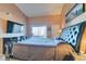 Comfortable primary bedroom with balcony access, large screen TV, and neutral color palette for a relaxing atmosphere at 7700 Constanso Ave # 204, Las Vegas, NV 89128