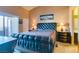 Comfortable primary bedroom featuring a tufted headboard, side tables, and natural light through the balcony door at 7700 Constanso Ave # 204, Las Vegas, NV 89128