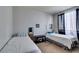 Clean bedroom featuring two twin beds, neutral walls, and a large window at 7700 Constanso Ave # 204, Las Vegas, NV 89128