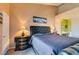 Inviting bedroom with a tufted headboard, bedside lamps, and adjacent bathroom access for added convenience at 7700 Constanso Ave # 204, Las Vegas, NV 89128