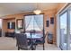 Cozy dining area with a round table, view of patio, and adjacent entertainment center at 7700 Constanso Ave # 204, Las Vegas, NV 89128
