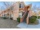 Inviting condo featuring manicured landscaping, two stories, and exterior stairs leading to the upper level at 7700 Constanso Ave # 204, Las Vegas, NV 89128