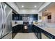 Clean kitchen with granite counters, stainless steel appliances, and dark cabinetry at 7700 Constanso Ave # 204, Las Vegas, NV 89128