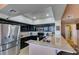 Well-lit kitchen featuring granite countertops, stainless steel appliances, and bright overhead lighting at 7700 Constanso Ave # 204, Las Vegas, NV 89128