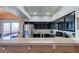 Modern kitchen featuring granite countertops, stainless steel appliances, and a breakfast bar at 7700 Constanso Ave # 204, Las Vegas, NV 89128