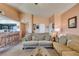 Spacious living room with plush sofas, breakfast bar, and seamless flow into the kitchen for easy living at 7700 Constanso Ave # 204, Las Vegas, NV 89128