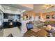 Open concept living space with a kitchen featuring black cabinets and stainless steel appliances at 7700 Constanso Ave # 204, Las Vegas, NV 89128