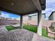 Enclosed patio featuring a stone patio, artificial grass, creating a cozy and private outdoor space at 7708 Mojave Wind Ave, Las Vegas, NV 89113