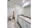 Bathroom featuring double sinks, large mirror, and a shower with patterned curtains at 7708 Mojave Wind Ave, Las Vegas, NV 89113