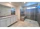 Modern bathroom with dual vanity, large walk-in shower, and contemporary fixtures at 7708 Mojave Wind Ave, Las Vegas, NV 89113