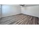 Spacious room with a ceiling fan, closet and wood-look laminate flooring at 7708 Mojave Wind Ave, Las Vegas, NV 89113