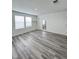 Bright bedroom featuring two windows and stylish laminate flooring, ready for personalization at 7708 Mojave Wind Ave, Las Vegas, NV 89113