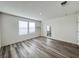 Bright bedroom featuring two windows and stylish laminate flooring, ready for personalization at 7708 Mojave Wind Ave, Las Vegas, NV 89113