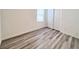 Bedroom featuring wood-look laminate flooring and a double closet door at 7708 Mojave Wind Ave, Las Vegas, NV 89113