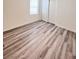 Bedroom featuring wood-look laminate flooring and a double closet door at 7708 Mojave Wind Ave, Las Vegas, NV 89113