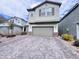 Charming two-story home with a stone-accented facade and well-manicured landscaping at 7708 Mojave Wind Ave, Las Vegas, NV 89113