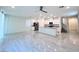 Open-concept living room with modern tile flooring, stainless steel appliances, and a large kitchen island at 7708 Mojave Wind Ave, Las Vegas, NV 89113