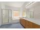 Bathroom with double sink vanity, a large mirror, tub, and glass shower at 774 Wigan Pier Dr, Henderson, NV 89002