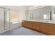 Bright bathroom with double sink vanity, large mirror, tub, and glass shower at 774 Wigan Pier Dr, Henderson, NV 89002