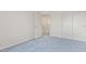 Bedroom with blue carpet, a closet, and open door at 774 Wigan Pier Dr, Henderson, NV 89002