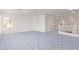 Bonus room featuring blue carpet, natural light, and stairs at 774 Wigan Pier Dr, Henderson, NV 89002
