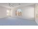 Bright bonus room featuring blue carpet, natural light, and large arched windows at 774 Wigan Pier Dr, Henderson, NV 89002