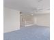 Bonus room featuring blue carpet, stairs, and a ceiling fan at 774 Wigan Pier Dr, Henderson, NV 89002
