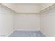 Bright closet with white walls, wooden bars for hanging and blue carpet at 774 Wigan Pier Dr, Henderson, NV 89002