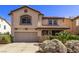 Two-story home features an attached two-car garage and well-maintained landscaping at 774 Wigan Pier Dr, Henderson, NV 89002