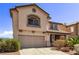 A front view of a two-story home showing a tile roof and a two car garage at 774 Wigan Pier Dr, Henderson, NV 89002