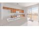 Bright kitchen with wood cabinets, white appliances, and granite counters at 774 Wigan Pier Dr, Henderson, NV 89002