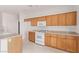 Bright kitchen featuring wooden cabinets, a white oven, and light countertops at 774 Wigan Pier Dr, Henderson, NV 89002