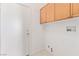Functional laundry room with overhead cabinets, and washer/dryer hookups at 774 Wigan Pier Dr, Henderson, NV 89002