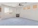Spacious living room featuring a cozy fireplace, ceiling fan, and well-lit interior at 774 Wigan Pier Dr, Henderson, NV 89002